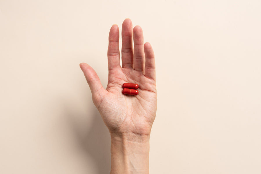 Red Tend-2 post-drinking capsules held in a hand